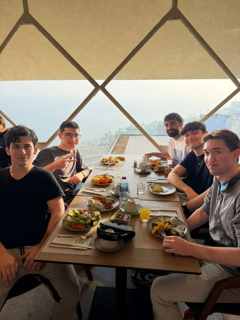 Akiva participants sharing a meal with a view of the sea